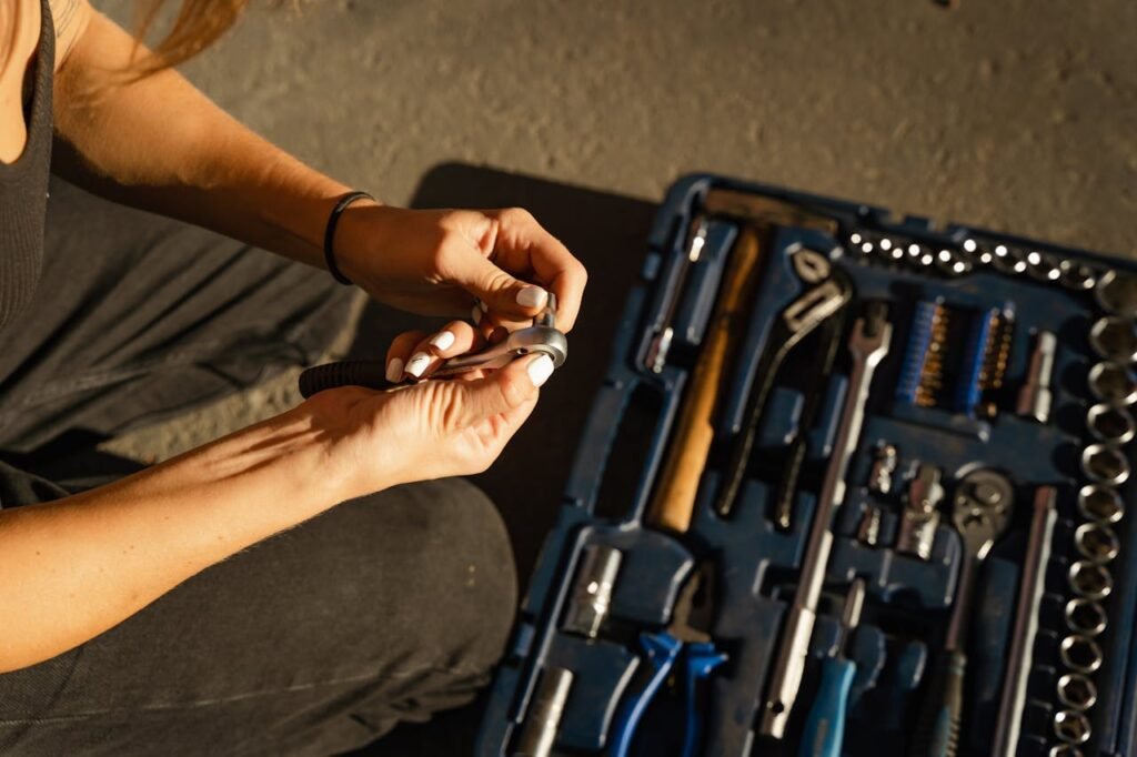 Hello world! Close-up of hands using tools from a toolset in a well-lit workshop setting.